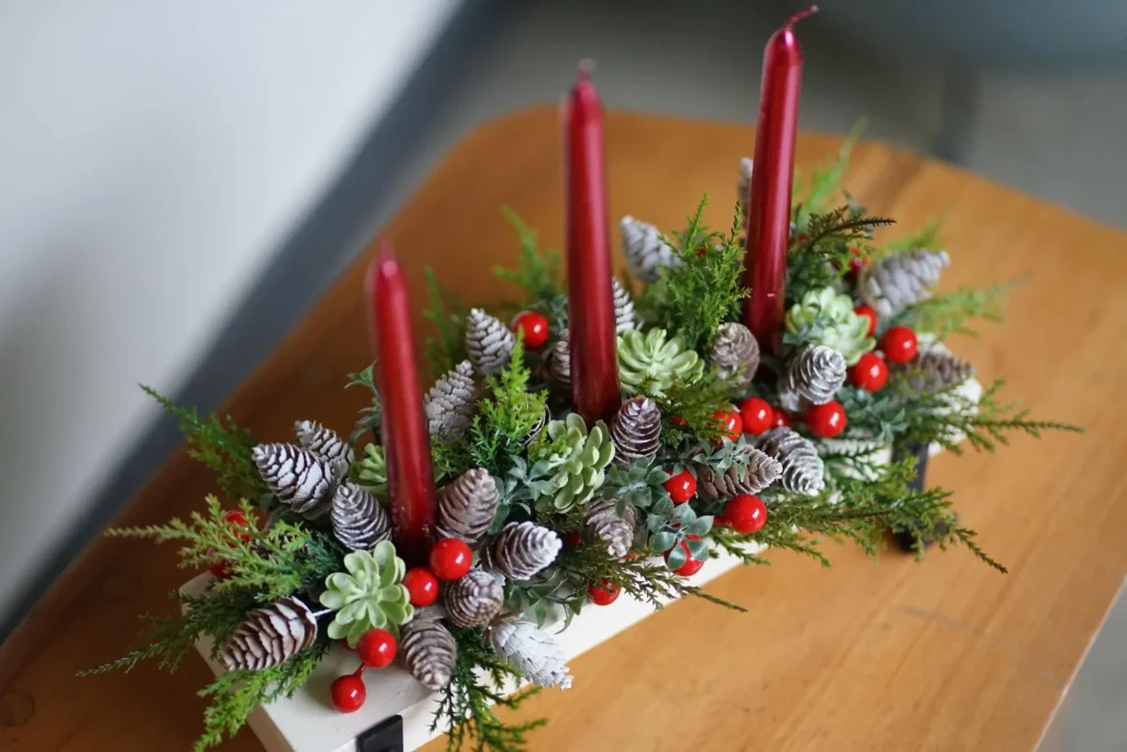 red candles and pine cones arranged on white wooden stand for modern classic home decor