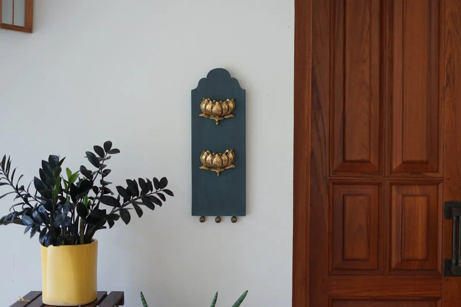 wall art in wood with bronze lotuses by a home decor store in kerala