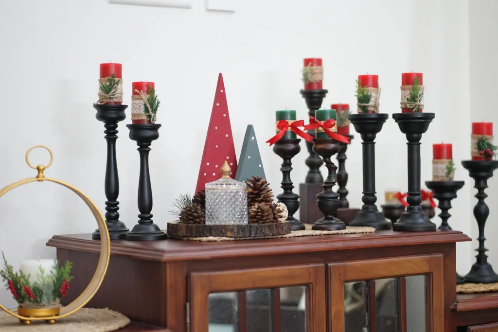 exquisite carved wooden candle stands by a home decor store in kerala