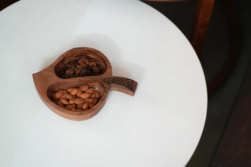 wooden serving bowl ideal for serving snacks done in a leaf shape by a home decor store in kerala