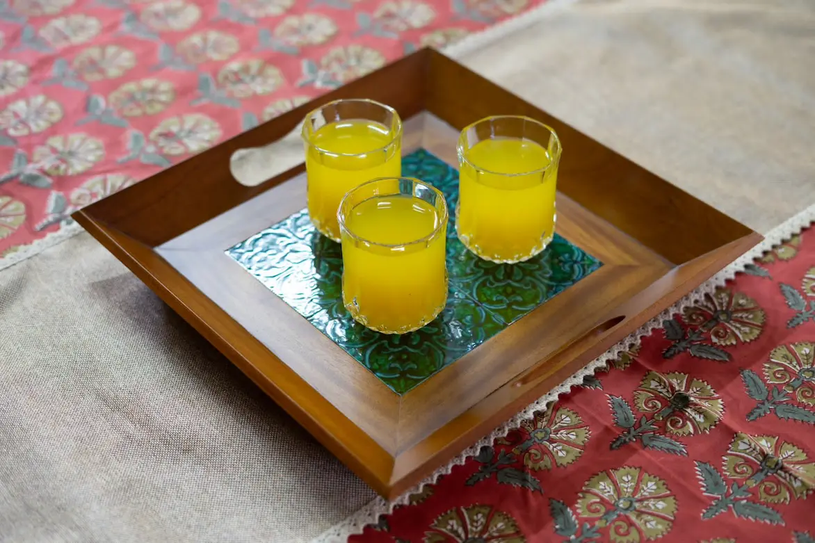 wooden tray with blue greeen  ceramic tiles inlay by a home decor store in kerala