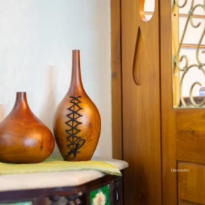 Wooden vase done using mahogany wood with a design of stitches as a modern home decor item for decorating living rooms 
