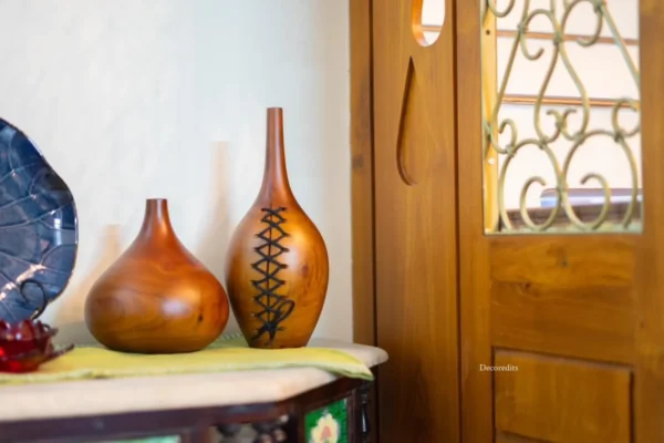 Wooden vase done using mahogany wood with a design of stitches as a modern home decor item for decorating living rooms